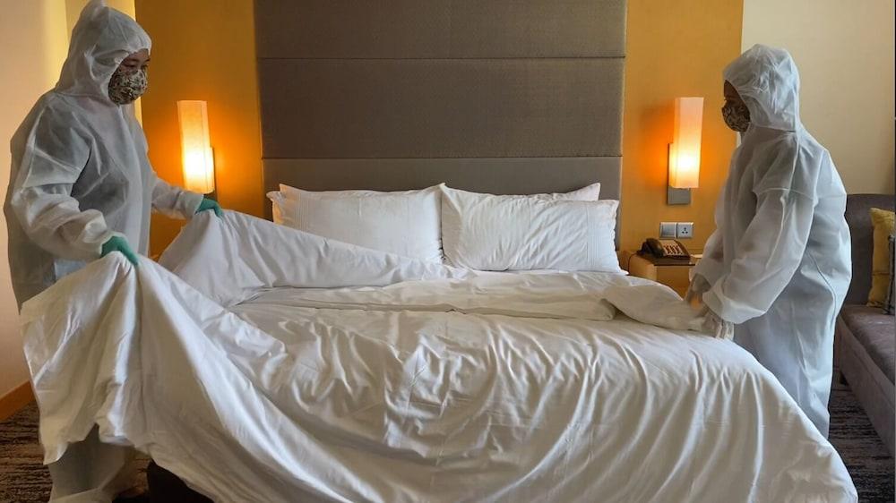 The Waterfront Hotel Kuching Ngoại thất bức ảnh Housekeeping staff making a bed