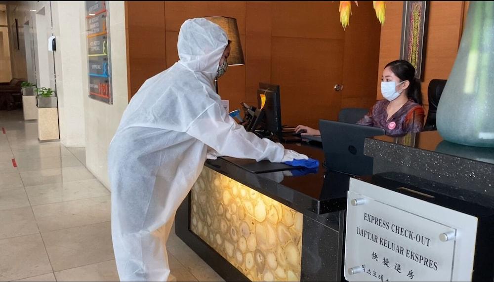 The Waterfront Hotel Kuching Ngoại thất bức ảnh A guest wearing a hazmat suit at a hotel in Beijing, China