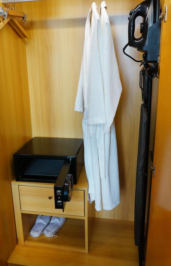 The Waterfront Hotel Kuching Ngoại thất bức ảnh A bathrobe hanging in a closet